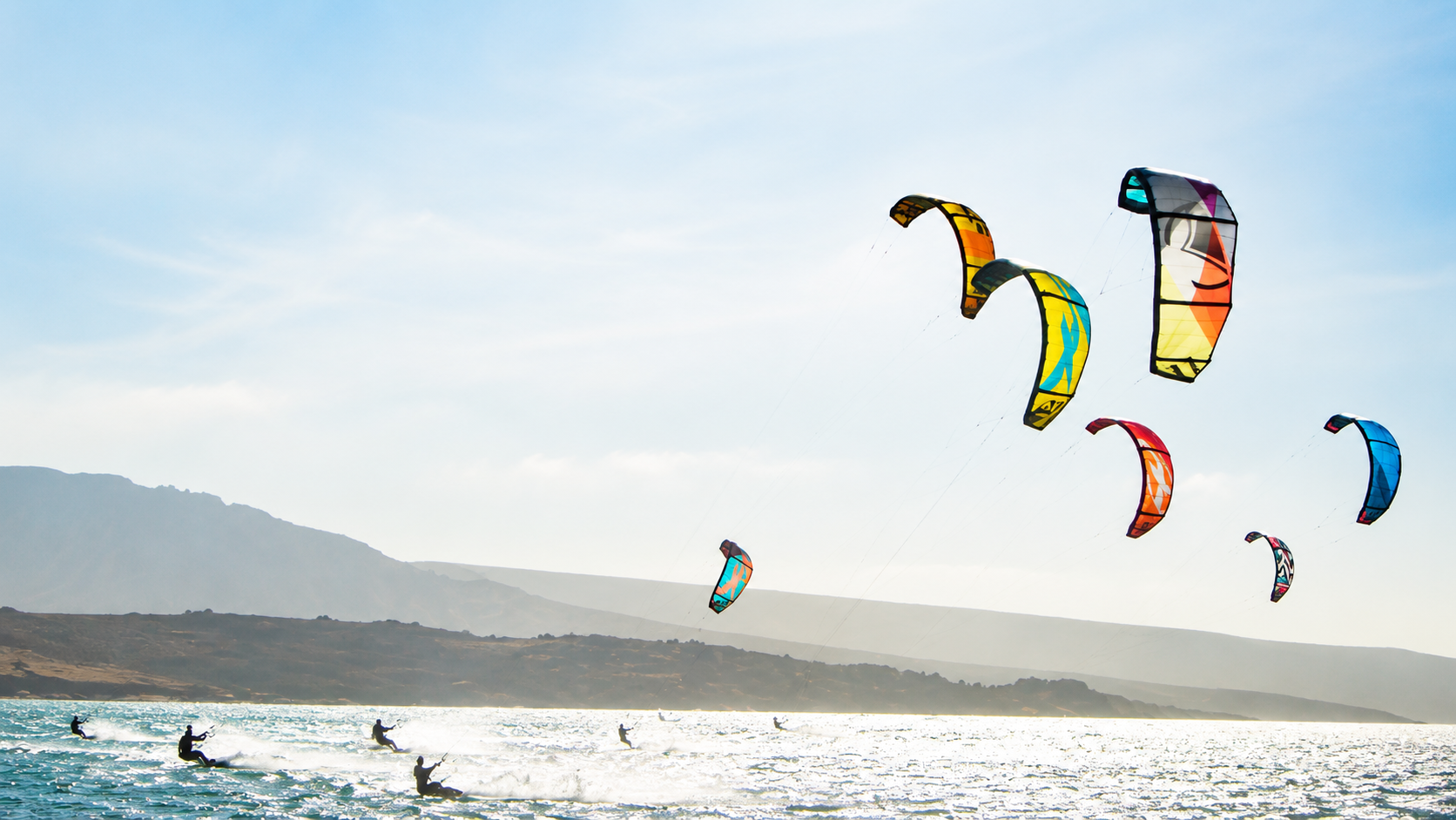 Colourful C-Kite kites flying over Langebaan Lagoon during a kitesurfing session